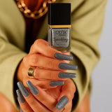 Platinum Twinkle Silver Nail Polish shown on painted nails holding bottle